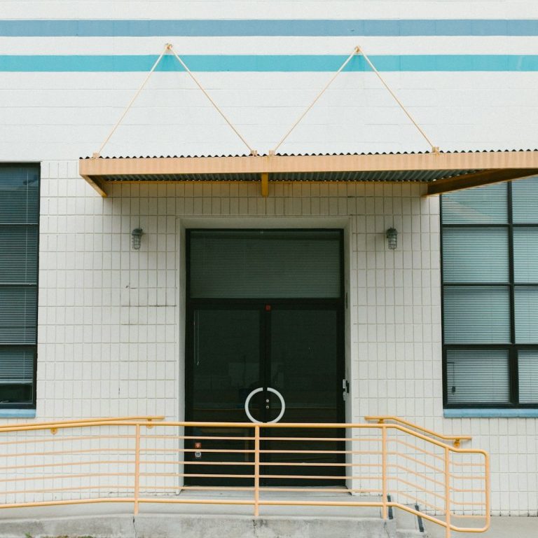 The front door to a cinder block office building.
